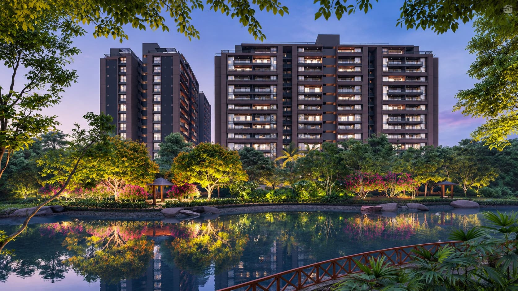 Parmeshwar Group residential towers at dusk, seen across a lit garden and lake