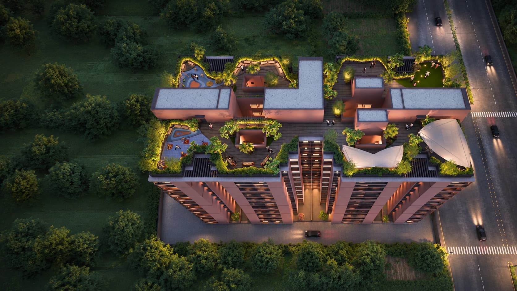 Sky Park by Parmeshwar from above at dusk: the landscaped rooftop, lit, among the trees beside the road.